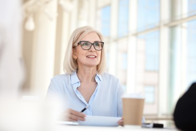 Frau mit blauer Bluse und Brille